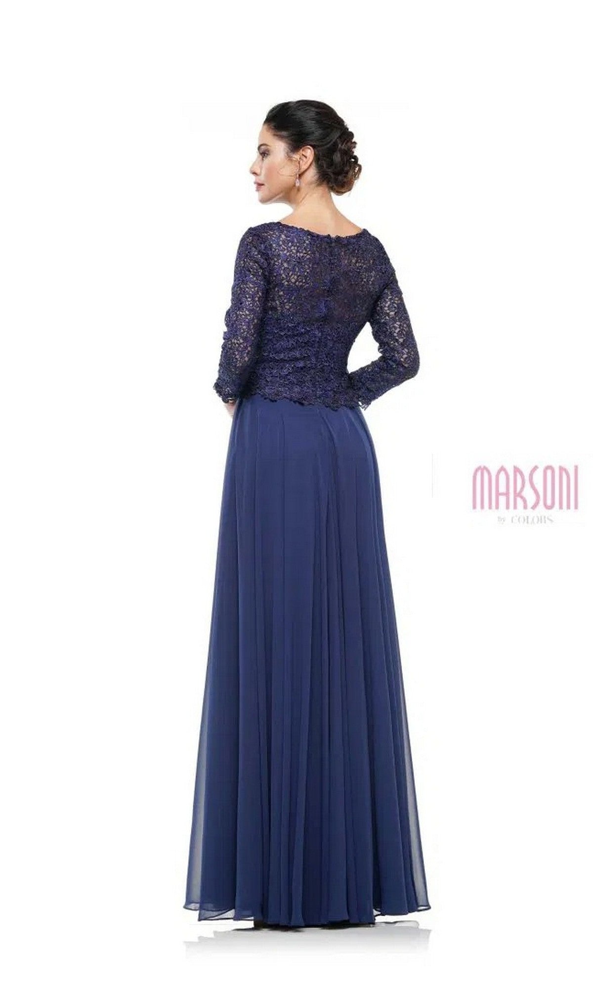 A woman stands with her back to the camera, wearing the Marsoni M223 Long Formal Dress—a full-length navy gown with a lace bodice and sheer long sleeves.